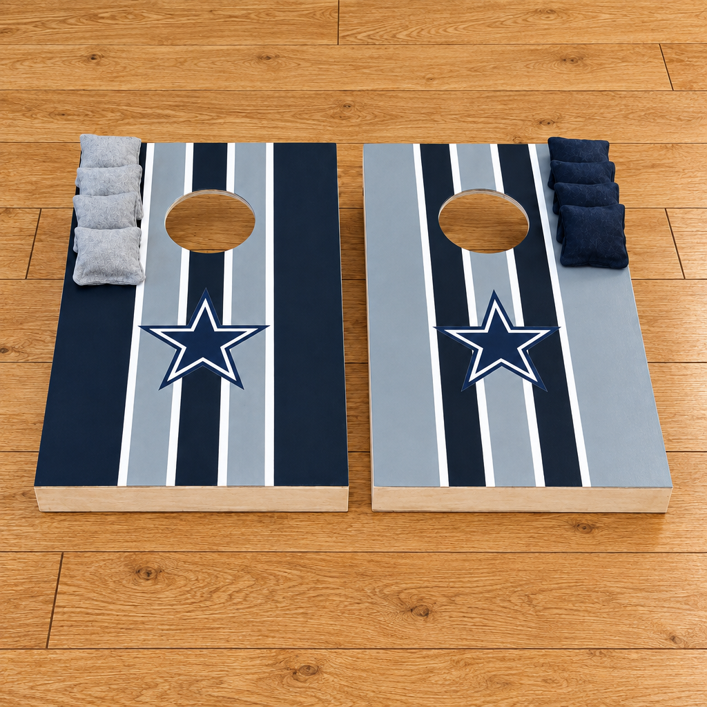 Hand-painted Dallas Cowboys cornhole boards with navy, grey and white stripes, star logo and bean bags on a wooden floor, square crop