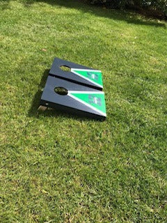 Side view of blue and green Seattle-themed wooden cornhole boards